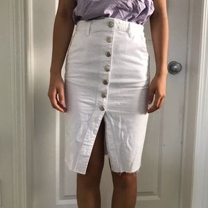 White denim skirt with button detailing.